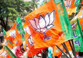File pic - A BJP worker waves party flag during a... File pic - A BJP worker waves party flag during a...
