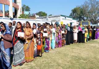 Women voters wait to cast their votes at a... Women voters wait to cast their votes at a...