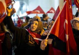 Demonstrators wave turkish flags outside the... Demonstrators wave turkish flags outside the...