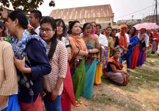 Voters stand in queues at a polling center to... Voters stand in queues at a polling center to...
