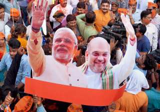 BJP workers carry a cut-out of PM Narendra Modi... BJP workers carry a cut-out of PM Narendra Modi...