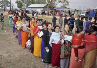 Voters stand in queues at a polling center to... Voters stand in queues at a polling center to...