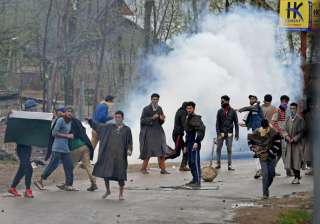 Youth pelting stones on security forces during... Youth pelting stones on security forces during...