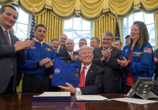 Trump signs NASA funding bill, sets goal of human... Trump signs NASA funding bill, sets goal of human...