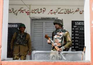 A jawan stand guard outside a polling station for... A jawan stand guard outside a polling station for...
