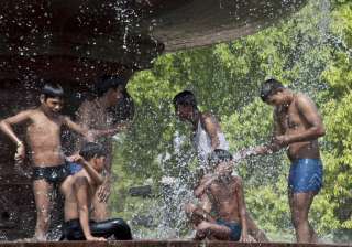 Youngsters splash water at a fountain near India... Youngsters splash water at a fountain near India...