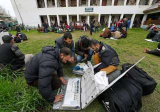 Polling staff checking EVMs before heading to... Polling staff checking EVMs before heading to...