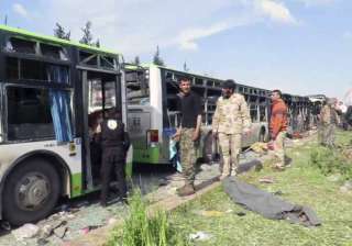 Rebel gunmen stand at the site of a blast - India... Rebel gunmen stand at the site of a blast - India...