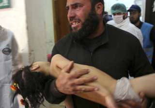 A man carrying a child following a suspected... A man carrying a child following a suspected...