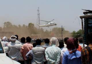 A crowd looks on as the helicopter with... A crowd looks on as the helicopter with...