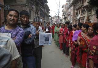 Nepalese stand in a queue to cast their votes... Nepalese stand in a queue to cast their votes...