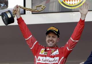 Sebastian Vettel celebrates after winning the... Sebastian Vettel celebrates after winning the...