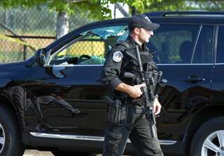 A policeman walks past a car with window damaged... A policeman walks past a car with window damaged...
