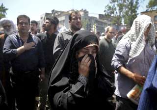 Iranians attend the funeral of victims of an... Iranians attend the funeral of victims of an...