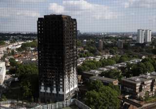 The remains of Grenfell Tower stand in London -... The remains of Grenfell Tower stand in London -...