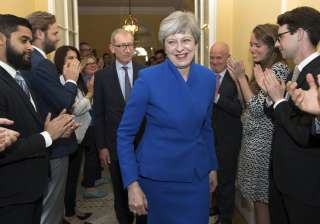 Britain's PM Theresa May applauded by staff as... Britain's PM Theresa May applauded by staff as...