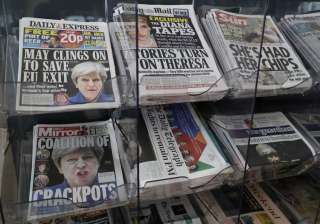 Newspapers fronted with photos of May are... Newspapers fronted with photos of May are...