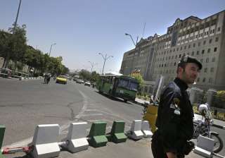 A police officer stands guard in front of... A police officer stands guard in front of...