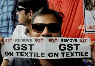 A textile trader with anti-GST poster during a... A textile trader with anti-GST poster during a...