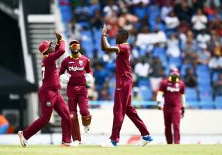 Alzarri Joseph R celebrates with teammates after... Alzarri Joseph R celebrates with teammates after...