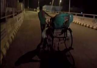 Family carries body on rickshaw after being... Family carries body on rickshaw after being...