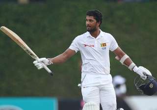 Dinesh Chandimal raises his bat to acknowledge... Dinesh Chandimal raises his bat to acknowledge...