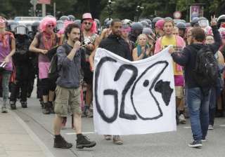 Protestors hold posters on the first day of G20... Protestors hold posters on the first day of G20...