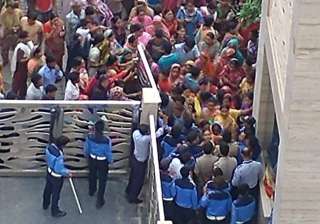 An angry mob pelted stones, breached the society... An angry mob pelted stones, breached the society...