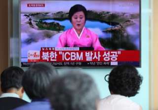 People watch a live TV report at Seoul Station on... People watch a live TV report at Seoul Station on...
