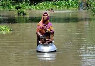 A woman with her child in flood affected... A woman with her child in flood affected...