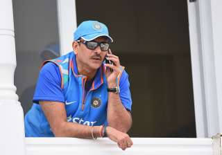 Ravi Shastri of India speaks on the phone during... Ravi Shastri of India speaks on the phone during...
