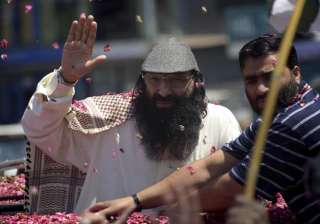 Syed Salahuddin waves to his supporters as he... Syed Salahuddin waves to his supporters as he...