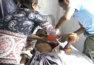 A man lying on a bed in a hospital in Buthidaung... A man lying on a bed in a hospital in Buthidaung...