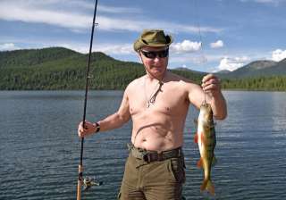 Putin holds a fish he caught during a mini-break... Putin holds a fish he caught during a mini-break...