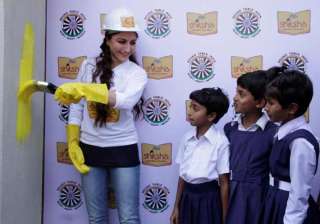 soha ali khan paints school wall to promote... soha ali khan paints school wall to promote...