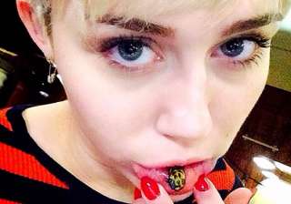 miley cyrus goes funky dons a tattoo on lower lip... miley cyrus goes funky dons a tattoo on lower lip...