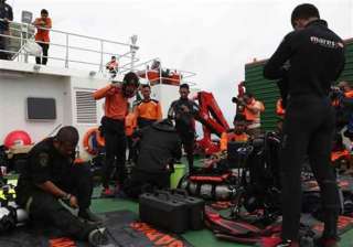 divers enter water in search of wreckage from... divers enter water in search of wreckage from...