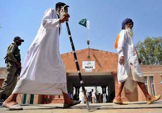 indian sikh pilgrims cross into pak on foot via... indian sikh pilgrims cross into pak on foot via...