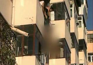 woman pulled to safety after dangling from fourth... woman pulled to safety after dangling from fourth...