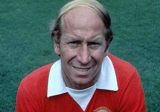 charlton carries olympic flame at old trafford -... charlton carries olympic flame at old trafford -...