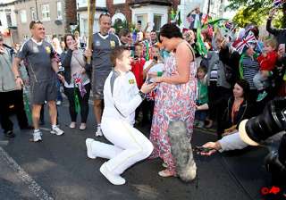 olympic torch bearer proposes during relay -... olympic torch bearer proposes during relay -...