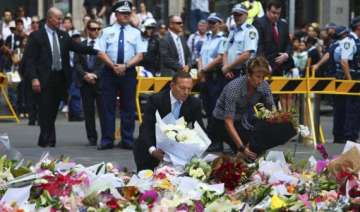 australian pm lays flowers at siege site - India... australian pm lays flowers at siege site - India...