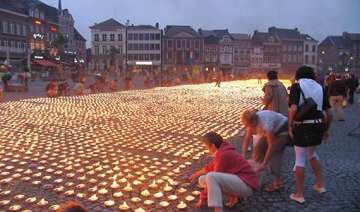 thousands help form giant candle star for charity... thousands help form giant candle star for charity...