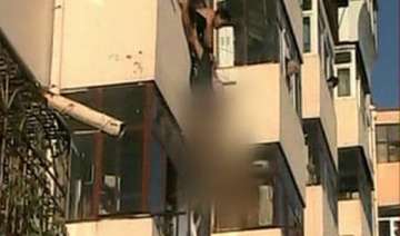 woman pulled to safety after dangling from fourth... woman pulled to safety after dangling from fourth...