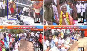 ap temple priest dances walks over women lying on... ap temple priest dances walks over women lying on...