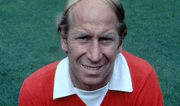 charlton carries olympic flame at old trafford -... charlton carries olympic flame at old trafford -...