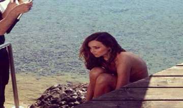 miranda kerr strips for a swimsuit shoot in... miranda kerr strips for a swimsuit shoot in...