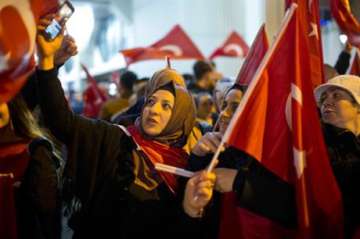 Demonstrators wave turkish flags outside the... Demonstrators wave turkish flags outside the...