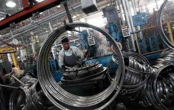 A worker at a manufacturing factory for cycle... A worker at a manufacturing factory for cycle...