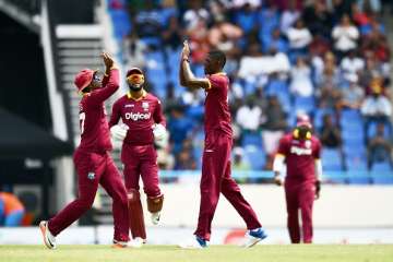 Alzarri Joseph R celebrates with teammates after... Alzarri Joseph R celebrates with teammates after...